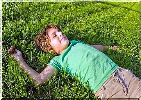 Boy lying in the grass