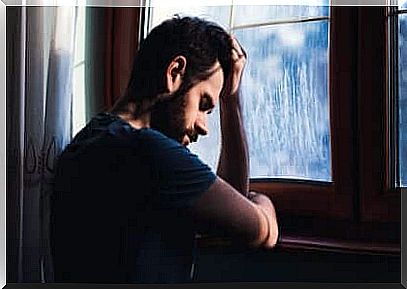 Sad man at window