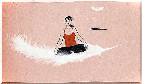 A woman meditates on a feather