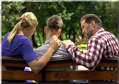 Three people sitting on a bench