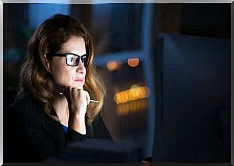 A woman staring at a computer