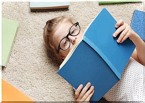 A girl lying on the floor reading