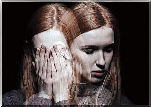 A split woman with her hands in front of her face and a mirror image of her looking sad.