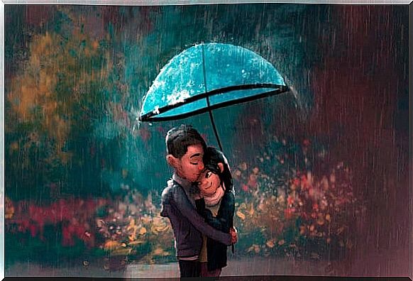 Couple hugging in the rain