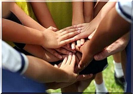 A photo of a group of hands touching each other