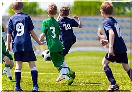 Several young boys playing soccer