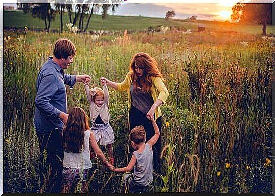 Family dancing on a meadow.