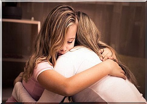 Girl hugging her mother.