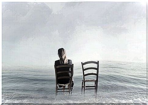 Woman sitting on a chair in the sea.