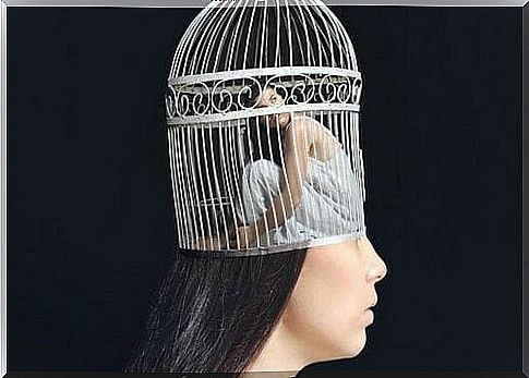 Woman holding a cage on her head.