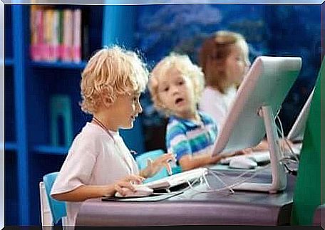 Three children in a computer lab