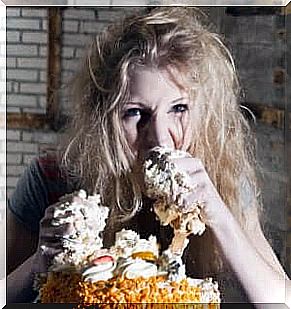 An, it seems, unstable woman feasting on cream cake with her hands