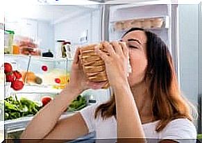 A woman poses with a huge sandwich