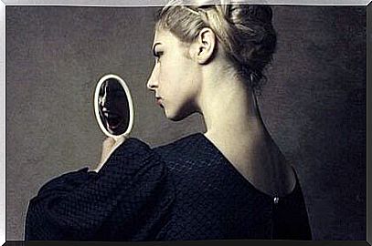 Woman looking at herself in the mirror